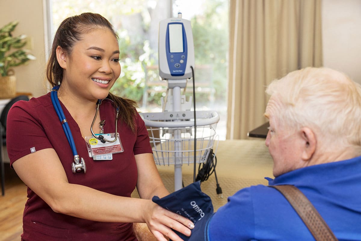 Oakwood Gardens nurse with a resident smiling