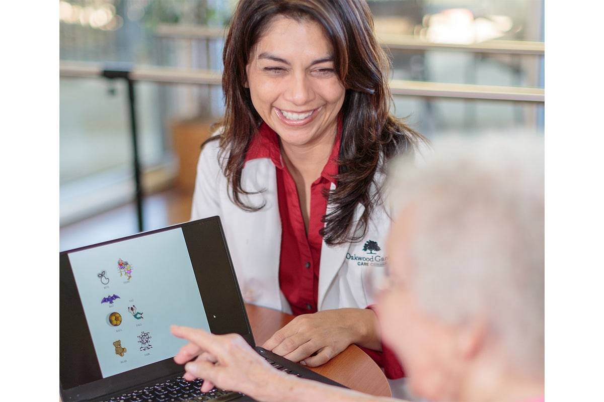 Oakwood Gardens speech therapist with an elderly resident